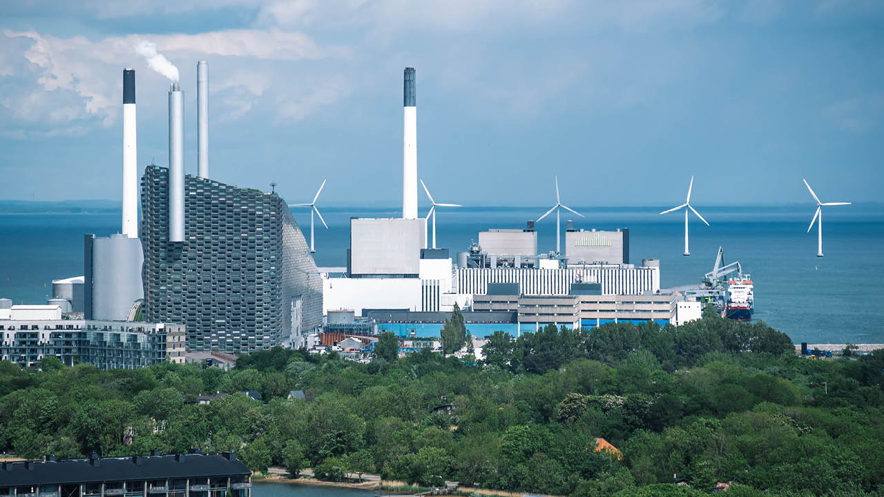 Areal view of Amager Bakke, Slope or Copenhill, incineration plant, heat and power waste-to-energy plant and offshore wind turbines power in the Baltic Sea