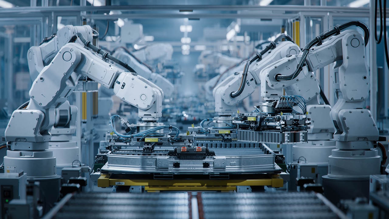Row of White Robotic Arms at Modern Factory. Lithium-Ion EV Battery Pack Production at Automated Assembly Line at Bright Factory Equipped With Industrial Robot Arms. Electric Car Manufacturing.